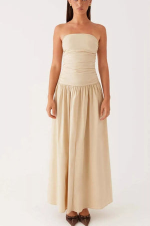 Ruched strapless maxi dress in cream with a flowing skirt and gathered waist detail.