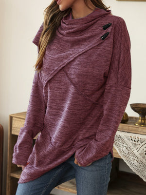 Deep purple knit sweater with asymmetric neckline and diagonal button detail.