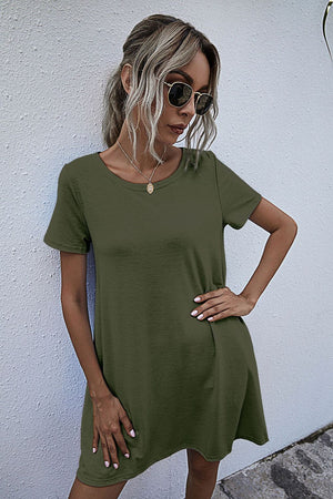 Army green relaxed tee dress with short sleeves and pockets, styled casually.