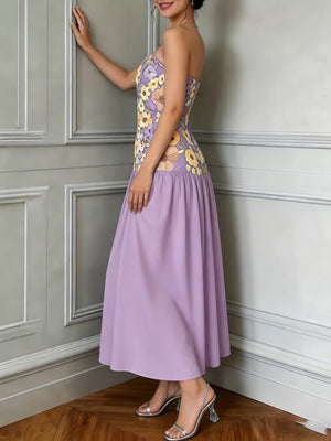 Strapless maxi dress in lavender with a floral embroidered bodice and tiered skirt.