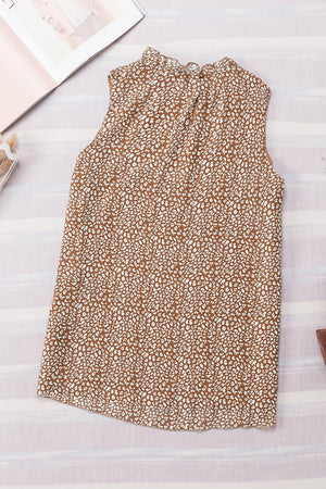 Brown printed sleeveless blouse with ruffled neckline.