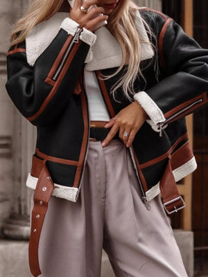 Black shearling lined zip up jacket with brown trim and white sherpa collar and cuffs.