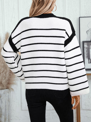 Contrast stripe knit sweater with wide sleeves and black trim.