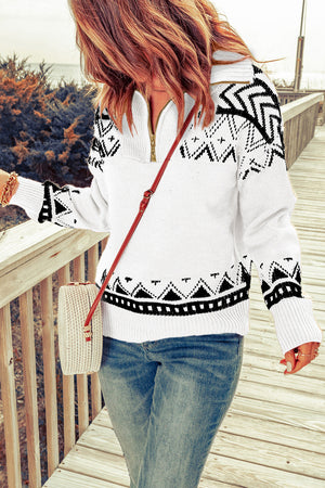 White geometric knit zip-neck pullover sweater with black pattern.