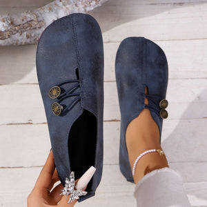 Blue round-toe casual flats with decorative buttons and elastic detail.