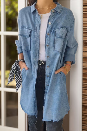 Light blue oversized denim shirt jacket with buttoned front and chest pockets.