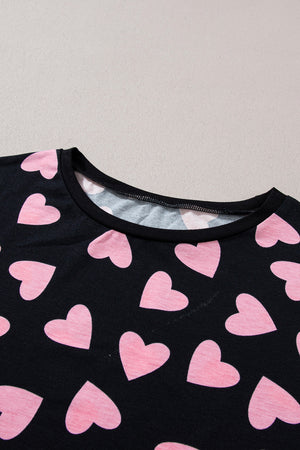 Black pajama top with pink heart print and crew neck