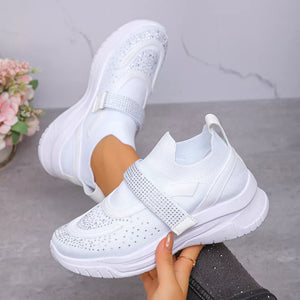 White mesh slip-on sneakers with adjustable rhinestone straps and crystal embellishments.