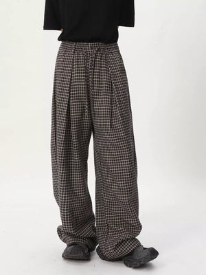 Plaid wide-leg relaxed fit pants in dark check with adjustable drawstring waist.