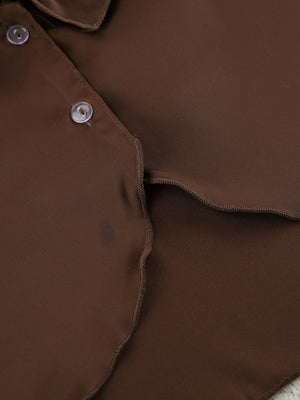 Chocolate ruffled V-neck pajama top detail with buttons and wavy hem.