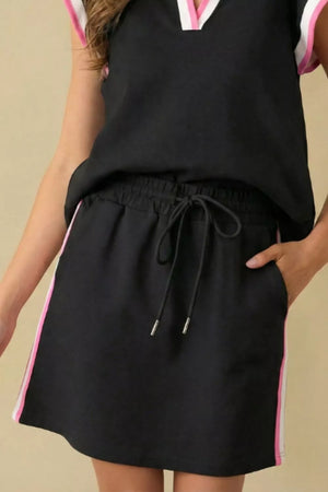Black blouse and shorts set with contrast trim and drawstring waist.