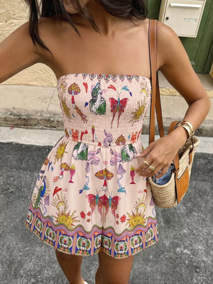 Smocked strapless romper with whimsical butterfly, mushroom, and sun print.