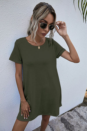 Relaxed pocketed tee dress in army green with short sleeves and a crew neck.