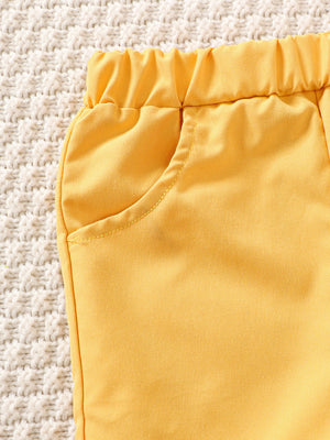 Yellow baby shorts with elastic waist and pocket detail
