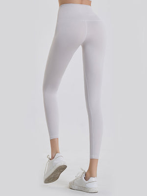 White 7/8 length leggings with a wide waistband and seamless stitching detail.