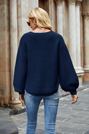 Navy balloon sleeve ribbed knit sweater with a textured pattern.