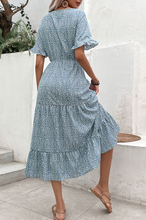Light blue floral tiered midi dress with ruffled short sleeves and a cinched waist.