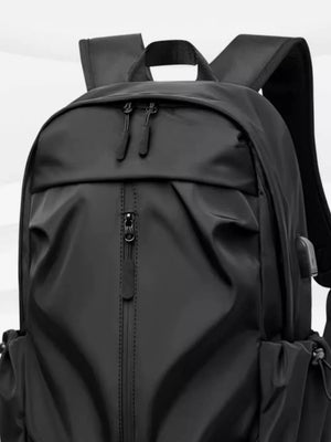 Black nylon drawstring backpack with zippered front pocket and side cinches.