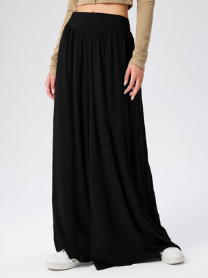 Black jersey wide-leg trousers with a drape-front and elastic waistband.