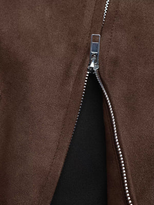 Brown zip-up jacket detail showing silver zipper and suede-like texture.