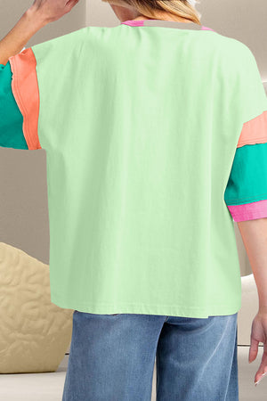 Raglan tee with colorblock sleeves in neon green, coral, and pink accents on a light green body.