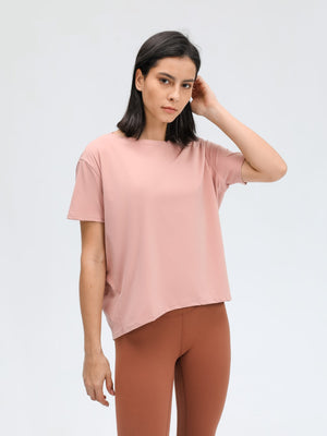 Relaxed fit performance tee in dusty rose with short sleeves and a boat neck.
