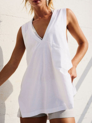 White wrap-front pocket tank top with a deep V-neck and sleeveless design.