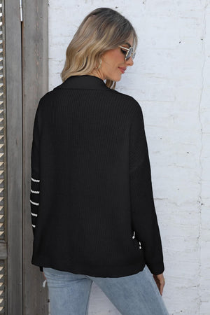 Black collared knit sweater with white stripe detail on sleeves.
