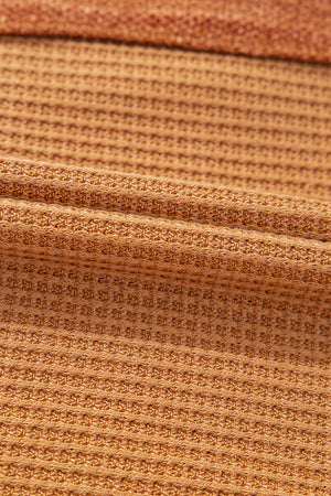 Caramel waffle knit henley top with contrast stitching detail.