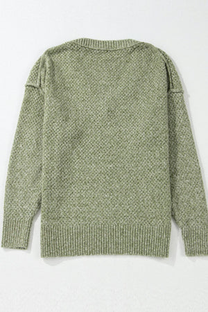 Open-knit slouchy V-neck sweater in matcha green with a textured pattern and ribbed cuffs and hem.