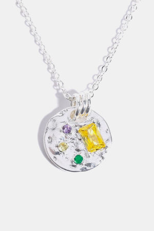 Silver textured disc pendant necklace with colorful gemstone accents