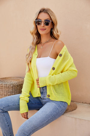 Yellow knit button-up cardigan with raglan sleeves and wooden buttons.