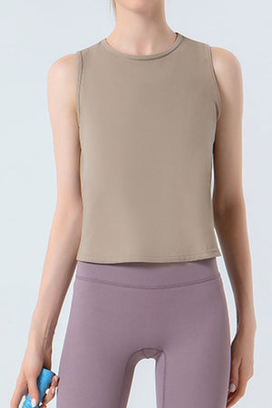 Tan sculpted performance tank top with a round neckline and sleeveless design.