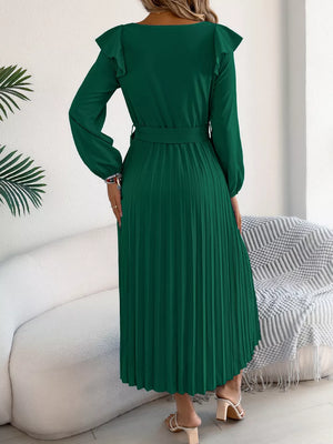 Green A-line midi dress with ruffled shoulders, long sleeves, belted waist, and pleated skirt.