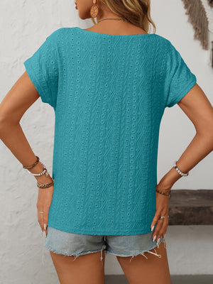 Teal eyelet knit tee with short sleeves and a boat neck, featuring a diamond pattern.