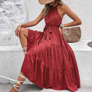 Burgundy halter neck tiered midi dress with belted waist and ruffle hem.