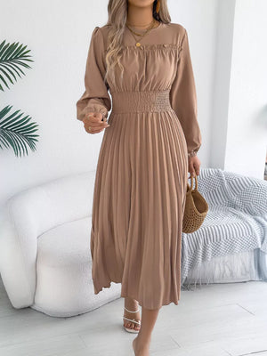 Khaki ruffled smocked waist midi dress with long sleeves and a pleated skirt.