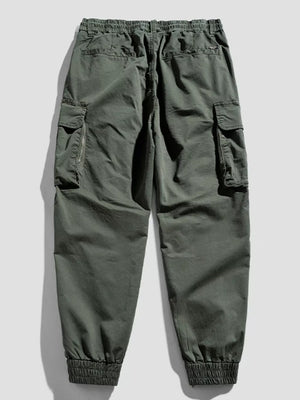 Army green cargo joggers with flap pockets and elastic cuffs.