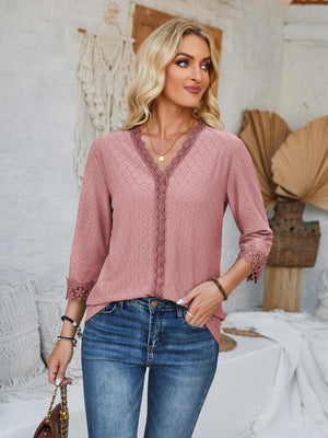 Dusty pink eyelet trim V-neck blouse with 3/4 sleeves and lace cuffs.