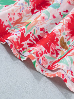 Floral print midi dress with tie shoulders, featuring a vibrant red and green floral pattern on white fabric.