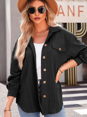 Textured oversized black button-down shacket with collared neckline and chest pockets.