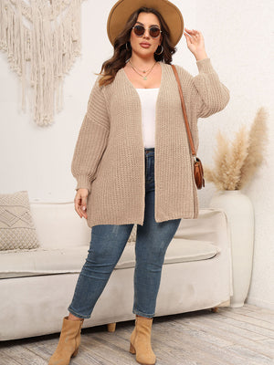 Chunky knit cardigan in tan with balloon sleeves and open front, styled with jeans.