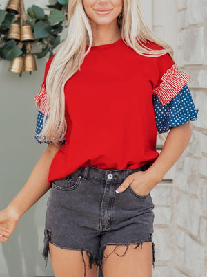 Ruffled patriotic graphic maternity t-shirt in red with star and stripe sleeves.