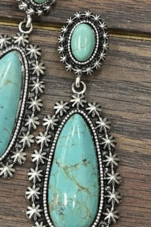 Teal artificial turquoise dangle earrings with silver starburst detail