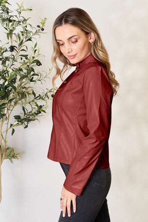 Biker-inspired faux leather jacket in Red Orange with a stand-up collar and zip closure.