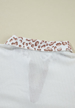 White waffle knit polo with leopard print collar detail