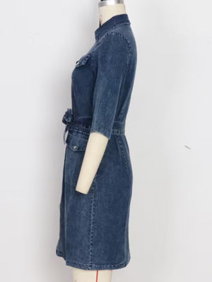 Denim shirt dress in blue with a zipper front, belted waist, and elbow-length sleeves.