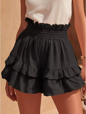 Black ruffled high-waisted shorts with smocked waistband and tiered hem.