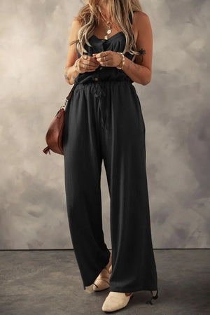 Black waffle knit wide leg jumpsuit with drawstring waist and button front.