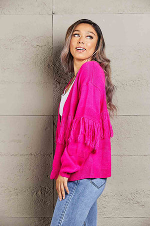 Hot Pink acrylic cardigan with fringe detail on the sleeves.
